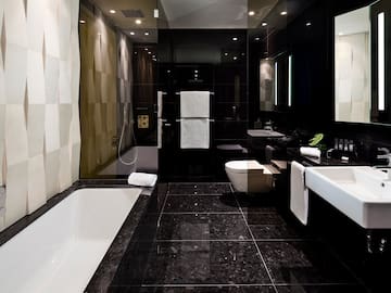 a bathroom with black tile floor