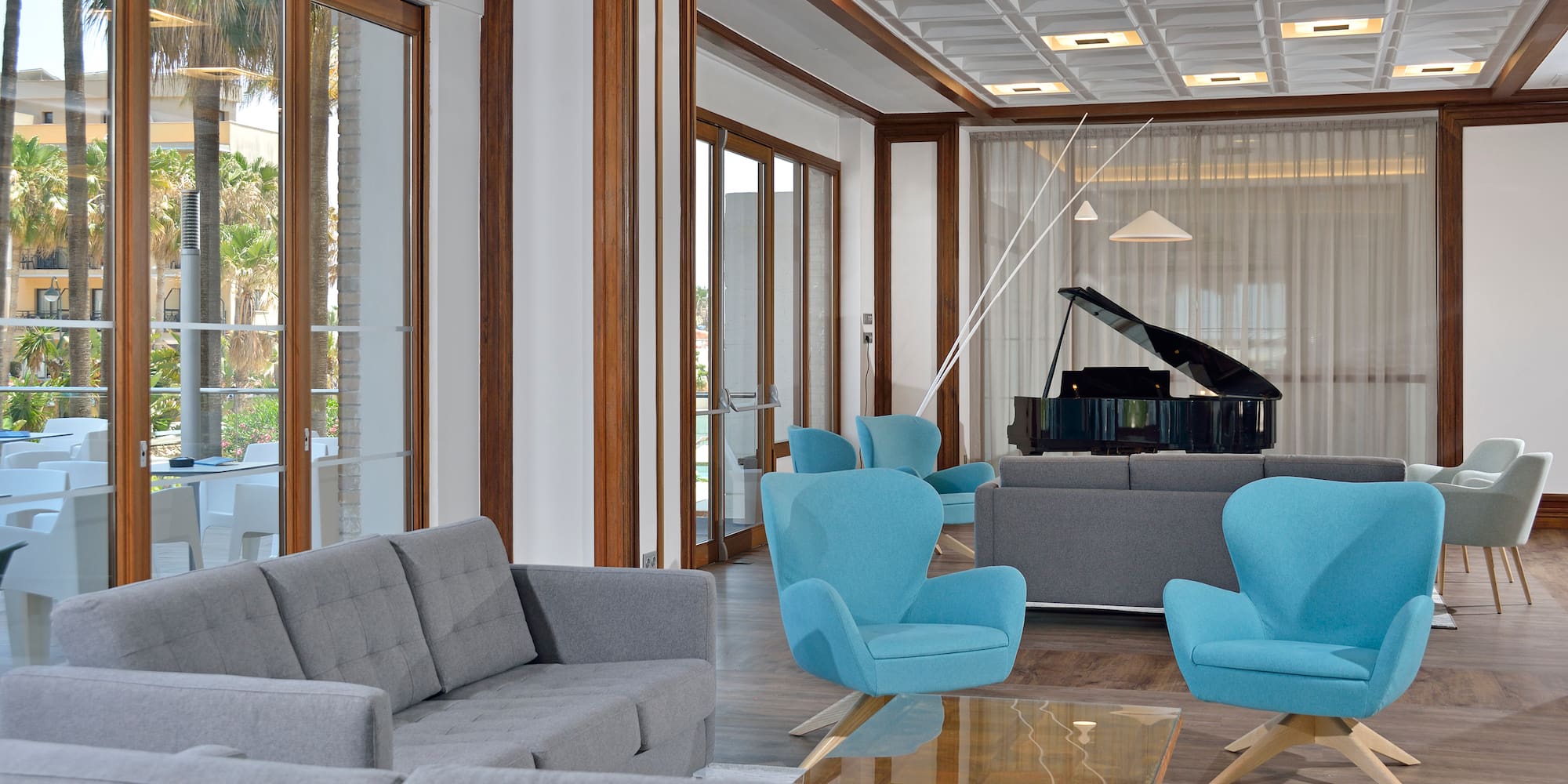 a room with a piano and chairs