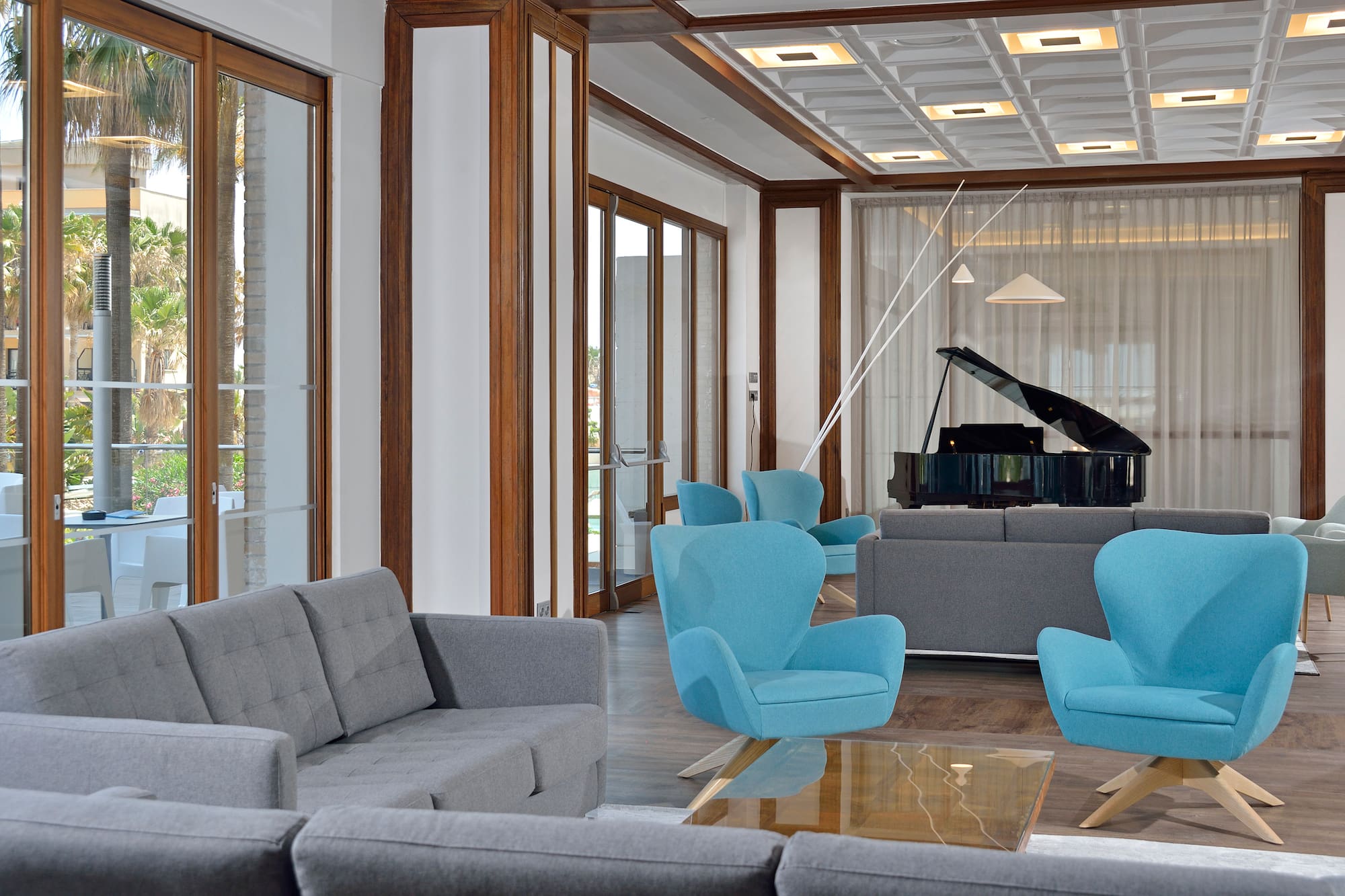 a room with a piano and chairs