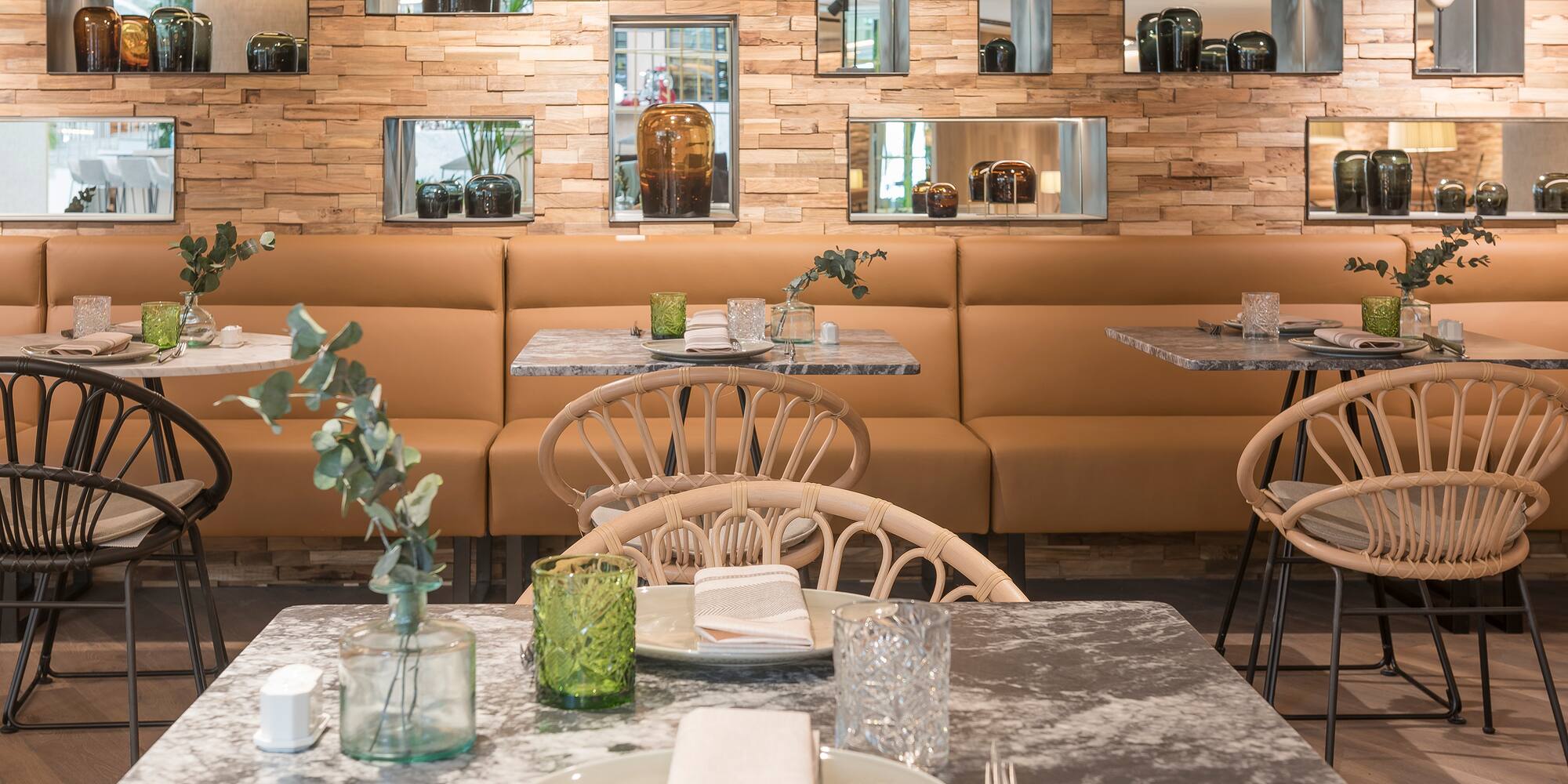 a table with plates and chairs in a restaurant
