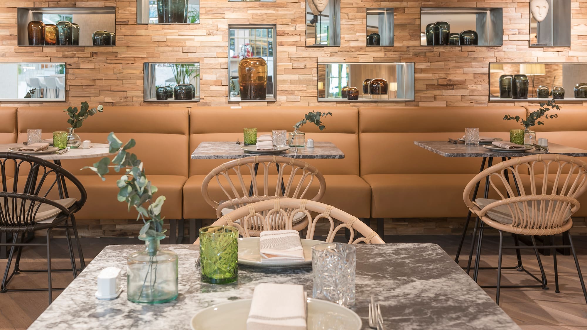 a table with plates and chairs in a restaurant