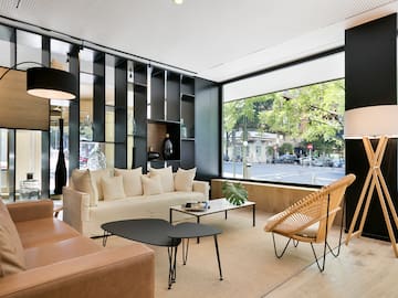 a room with a couch and chairs