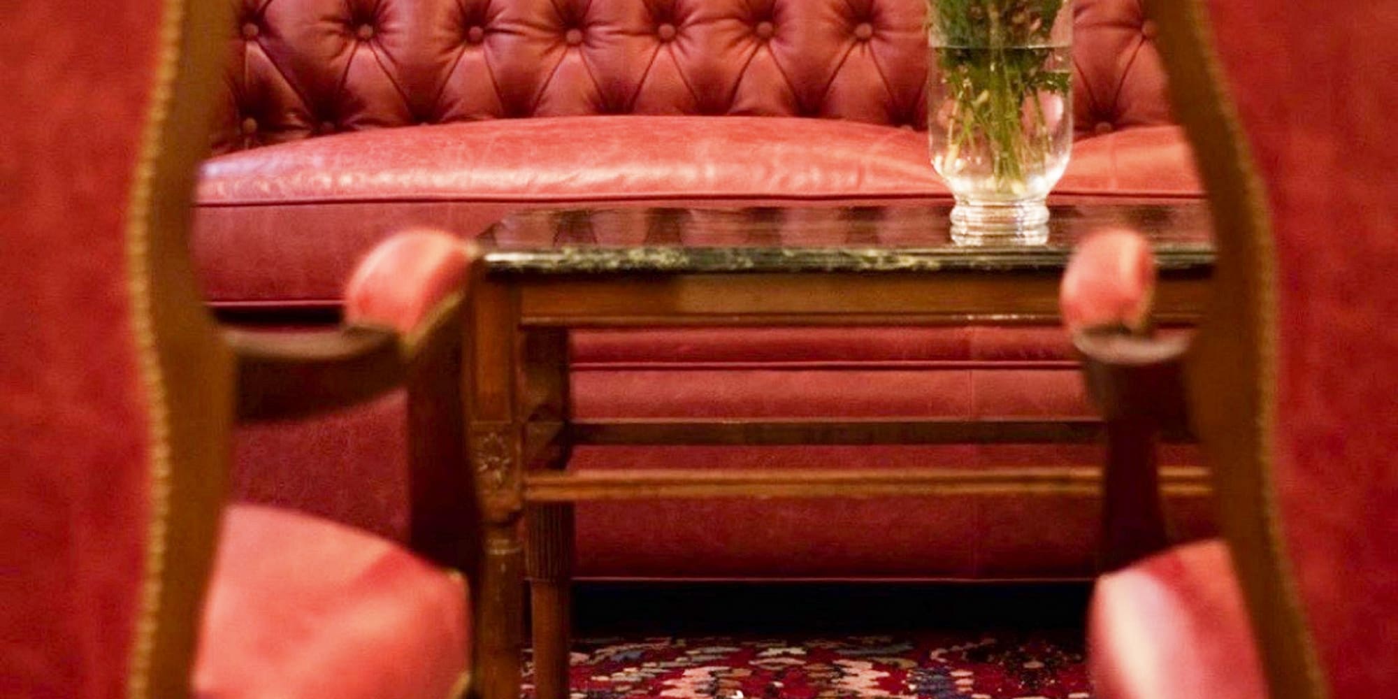 a red couch and chairs in a room