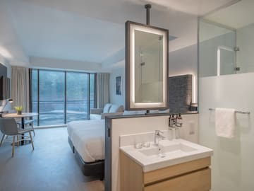 a bathroom with a bed and sink