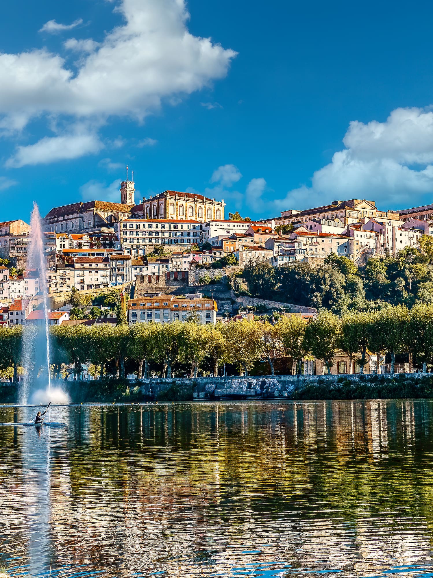 a water fountain in front of a city