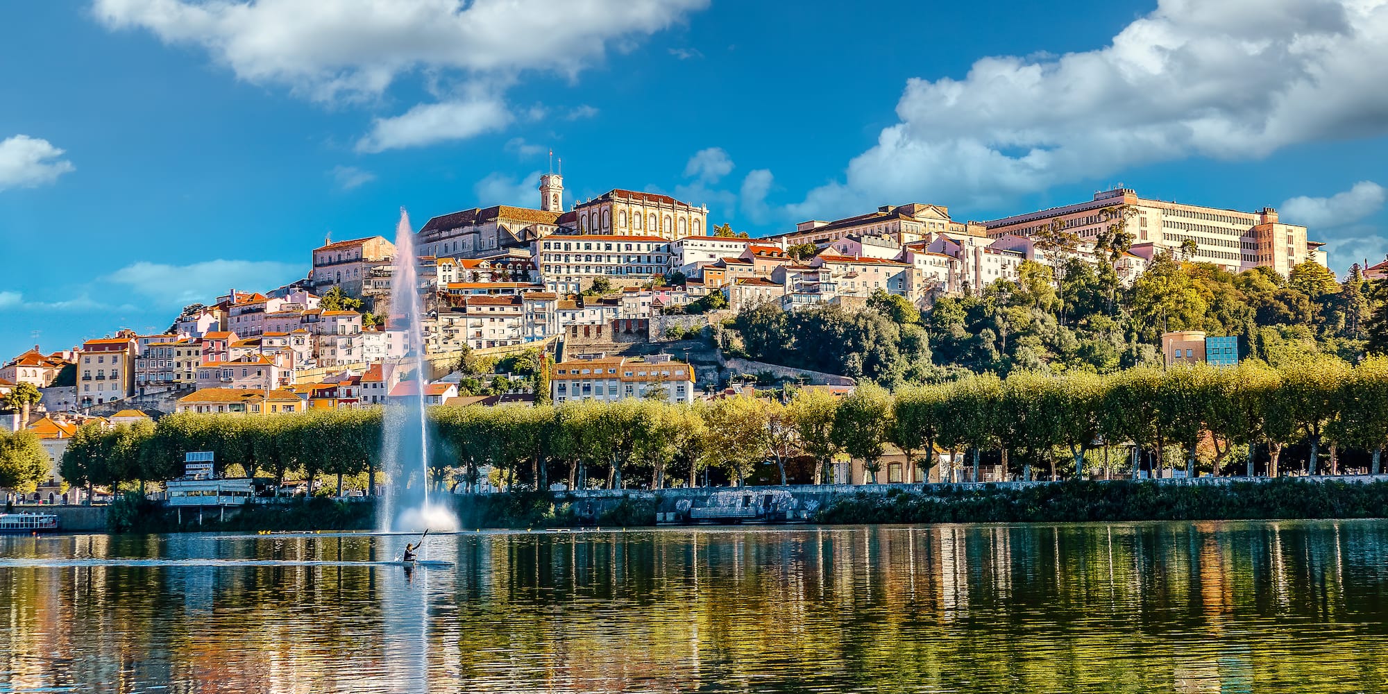 a water fountain in front of a city