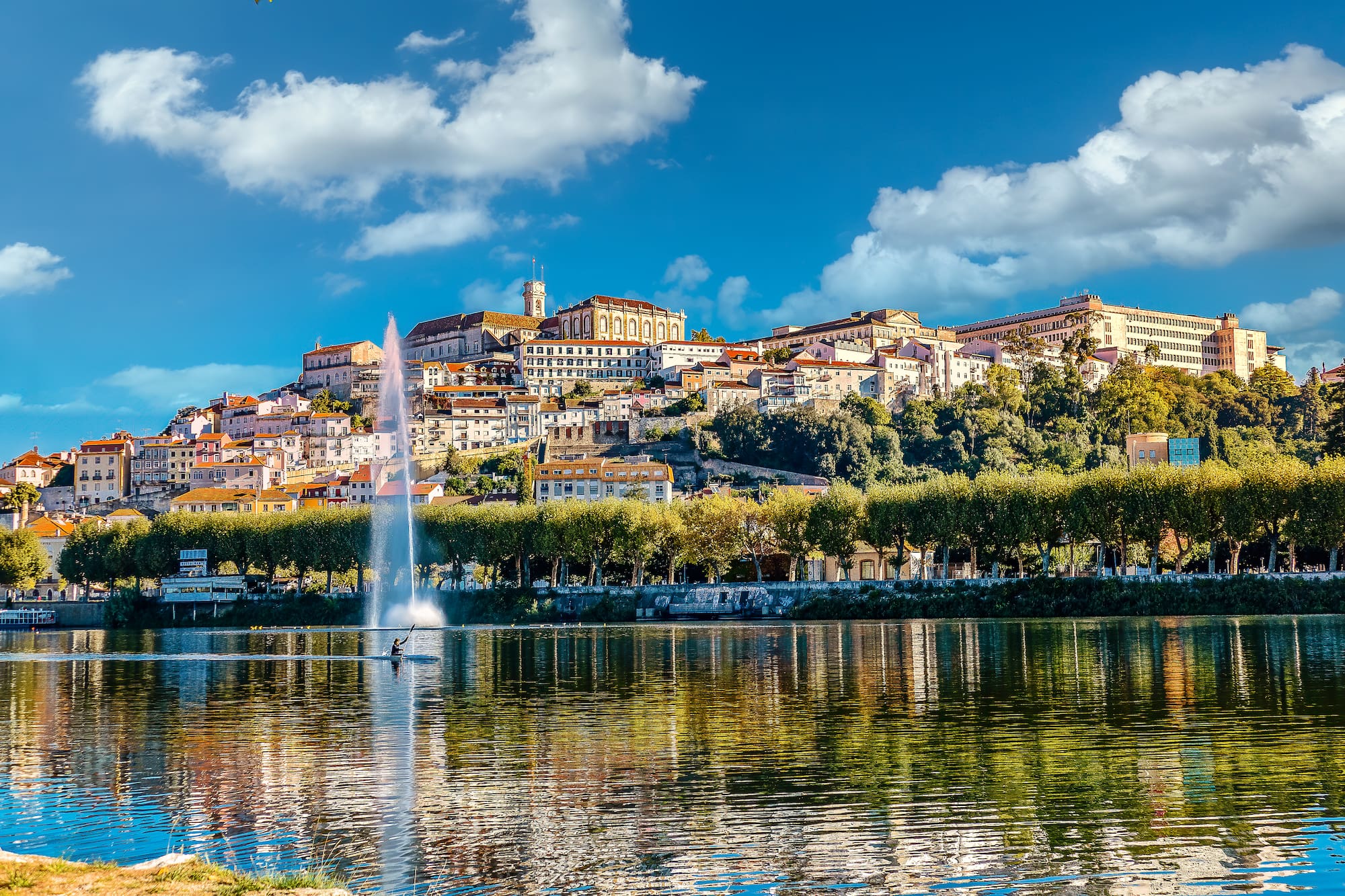 a water fountain in front of a city