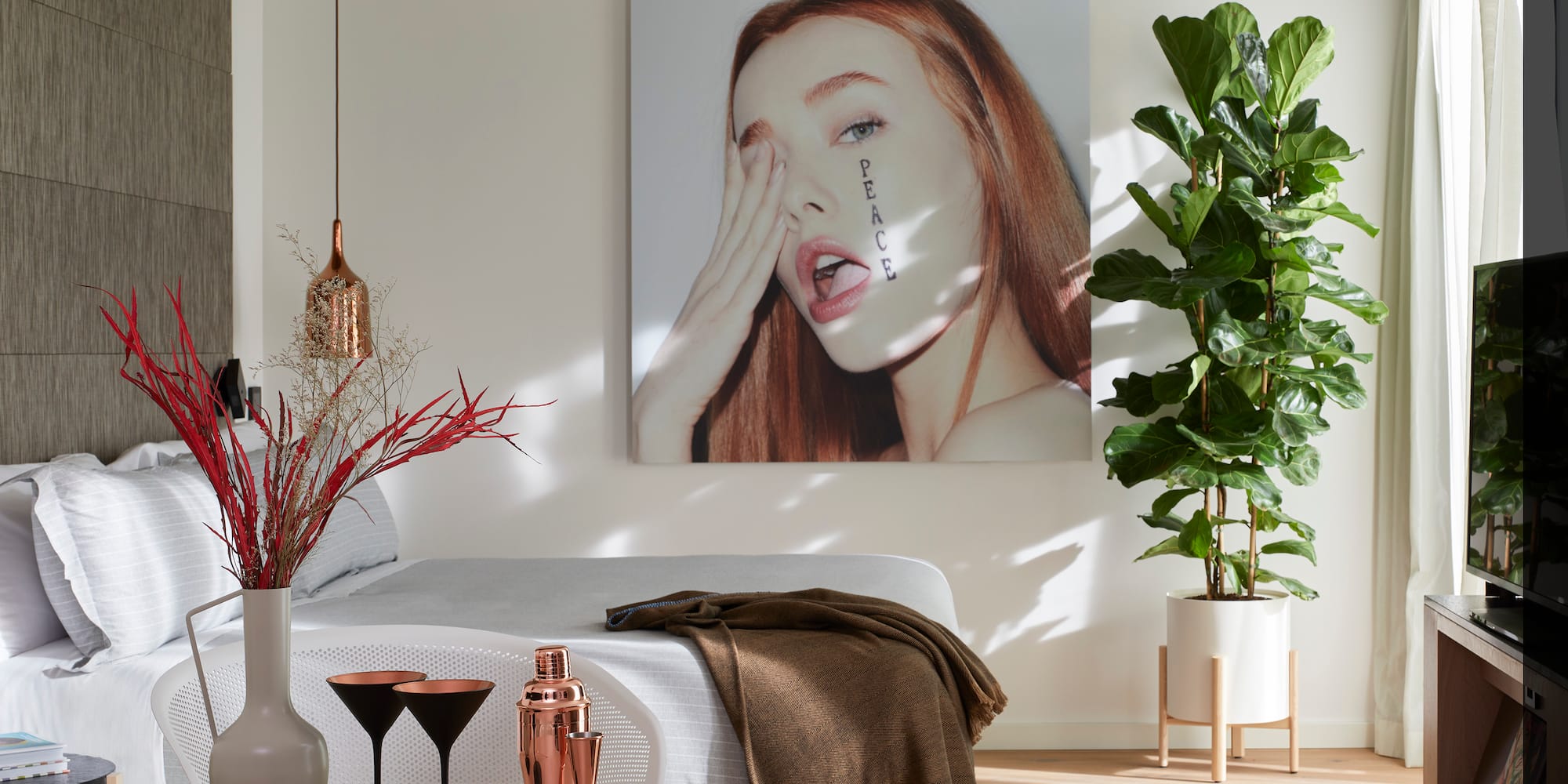 a room with a bed and a picture of a woman