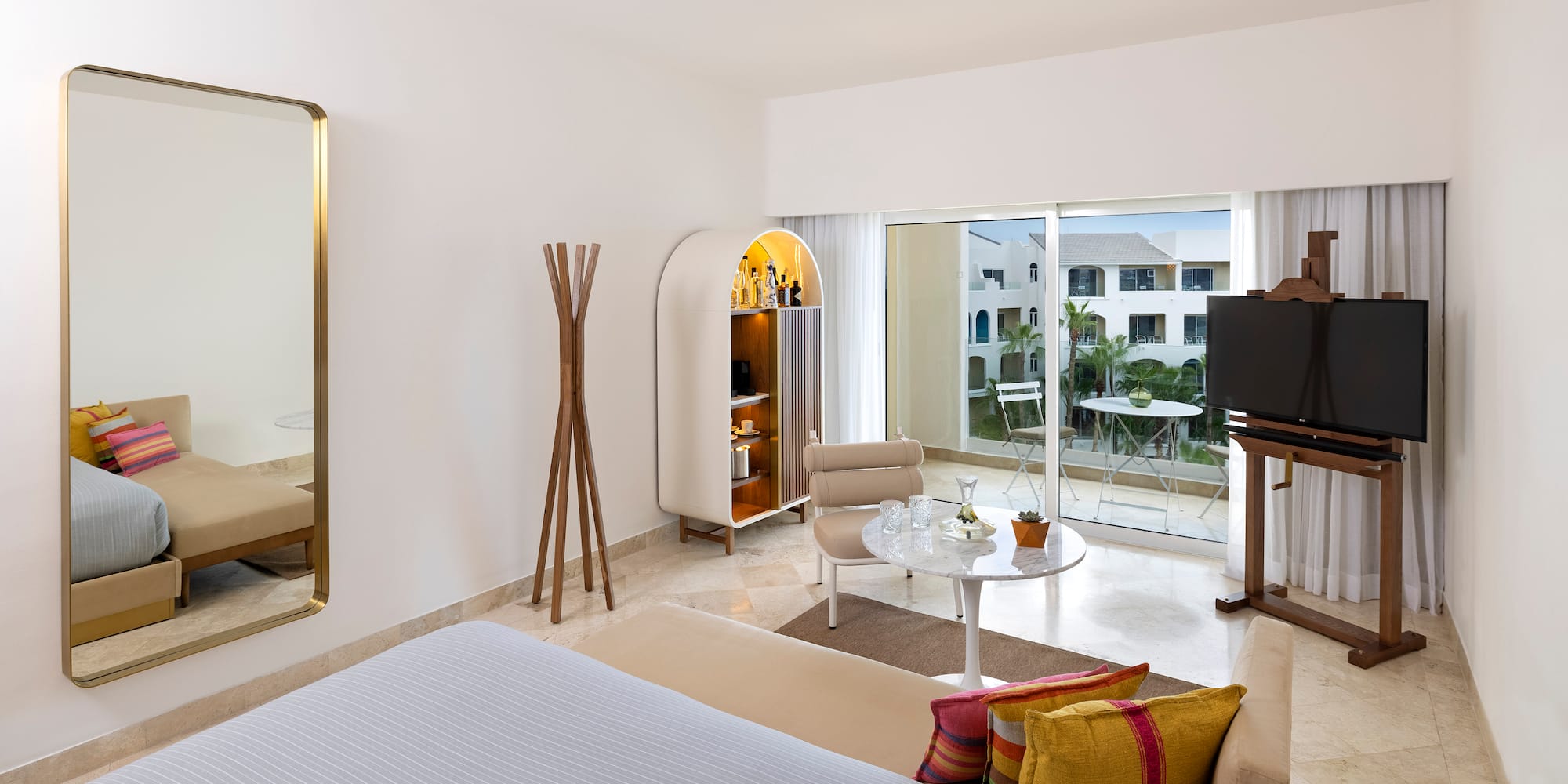 a room with a bed and a table and chairs