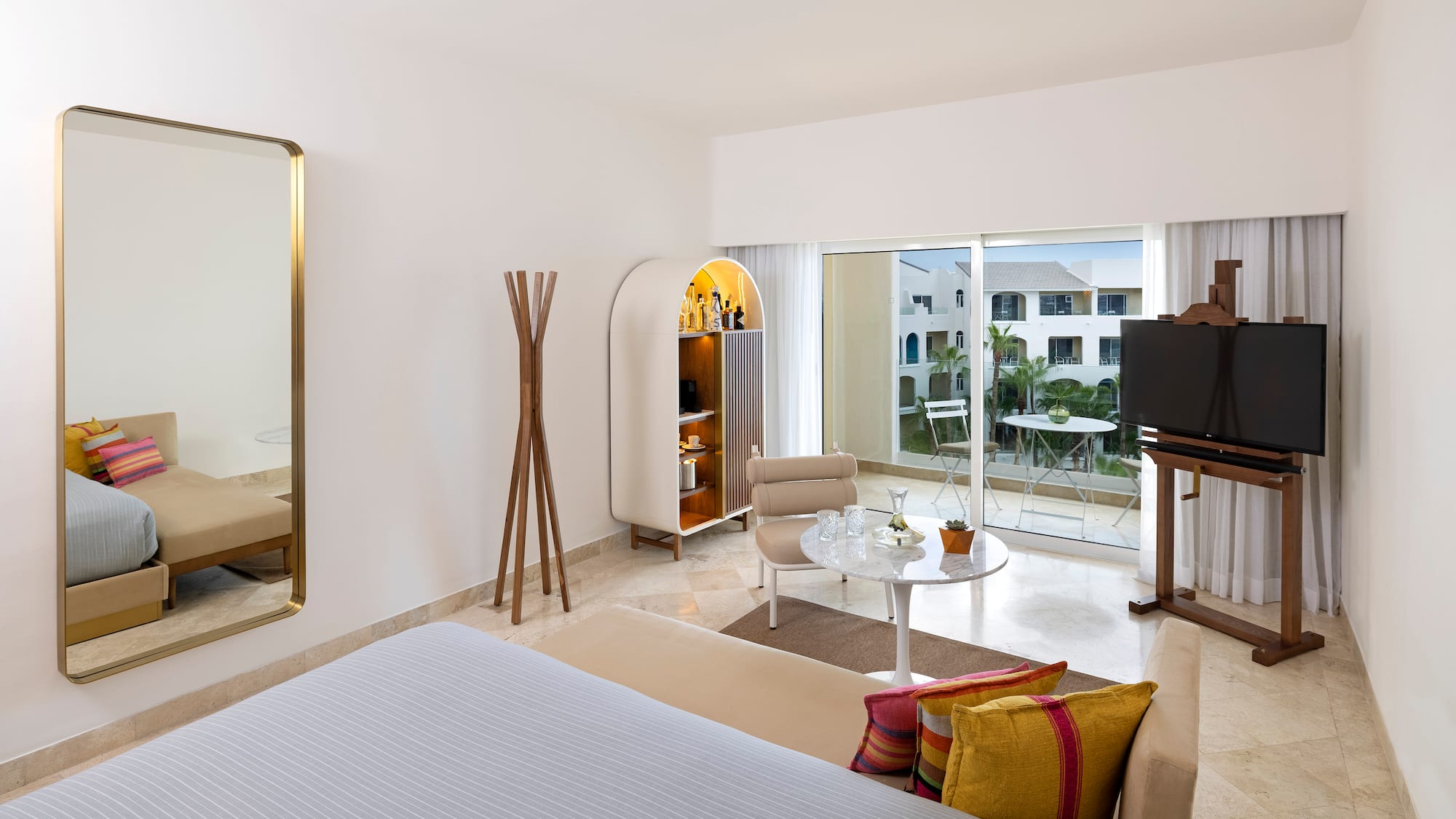 a room with a bed and a table and chairs