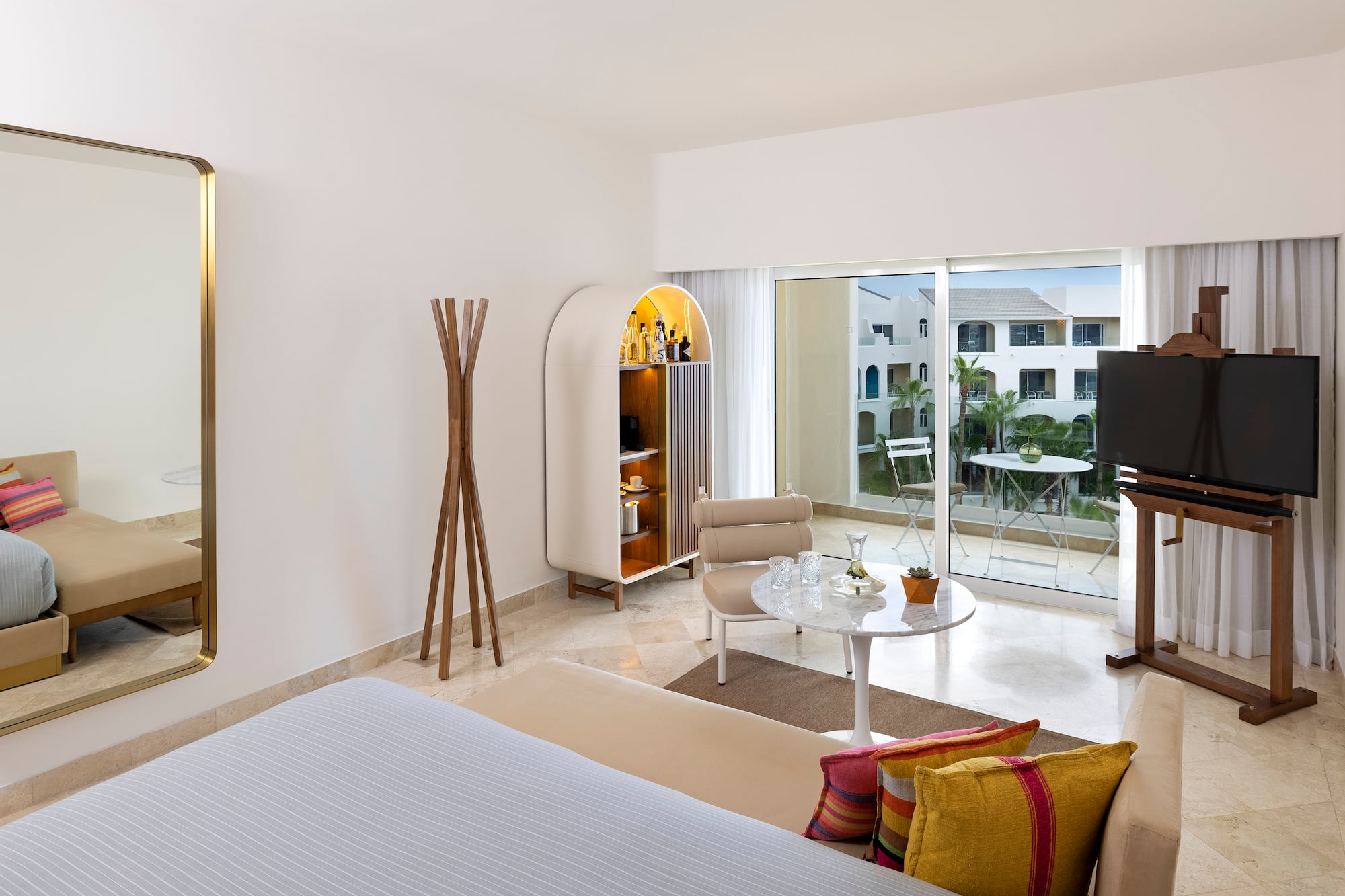 a room with a bed and a table and chairs