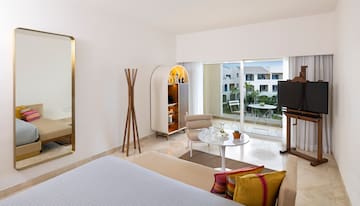 a room with a bed and a table and chairs