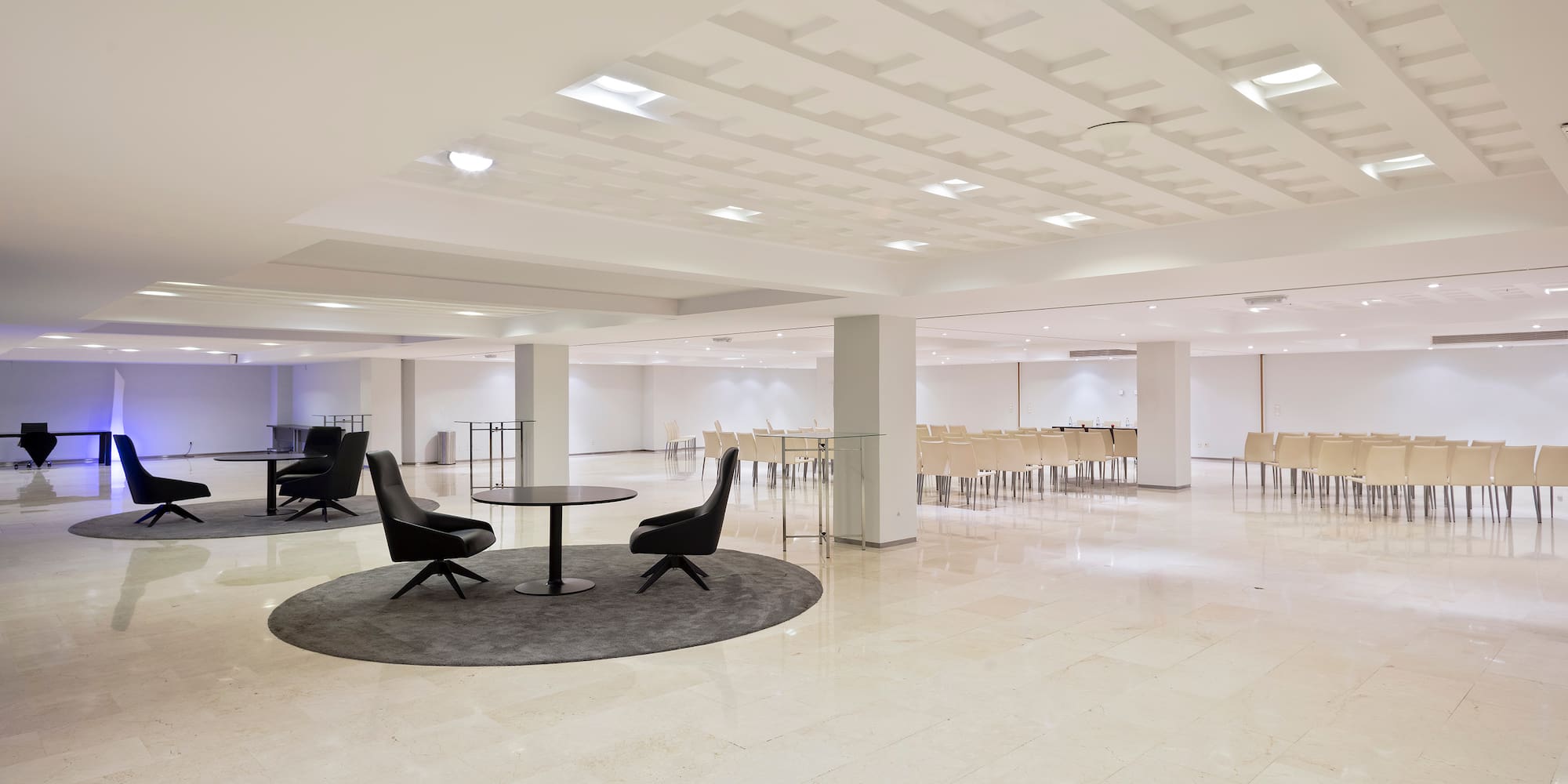 a room with a round table and chairs