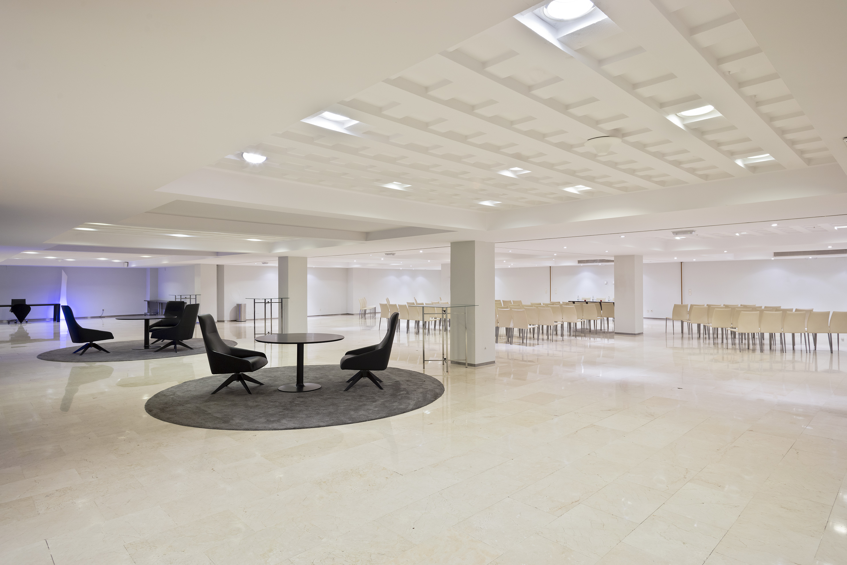 a room with a round table and chairs