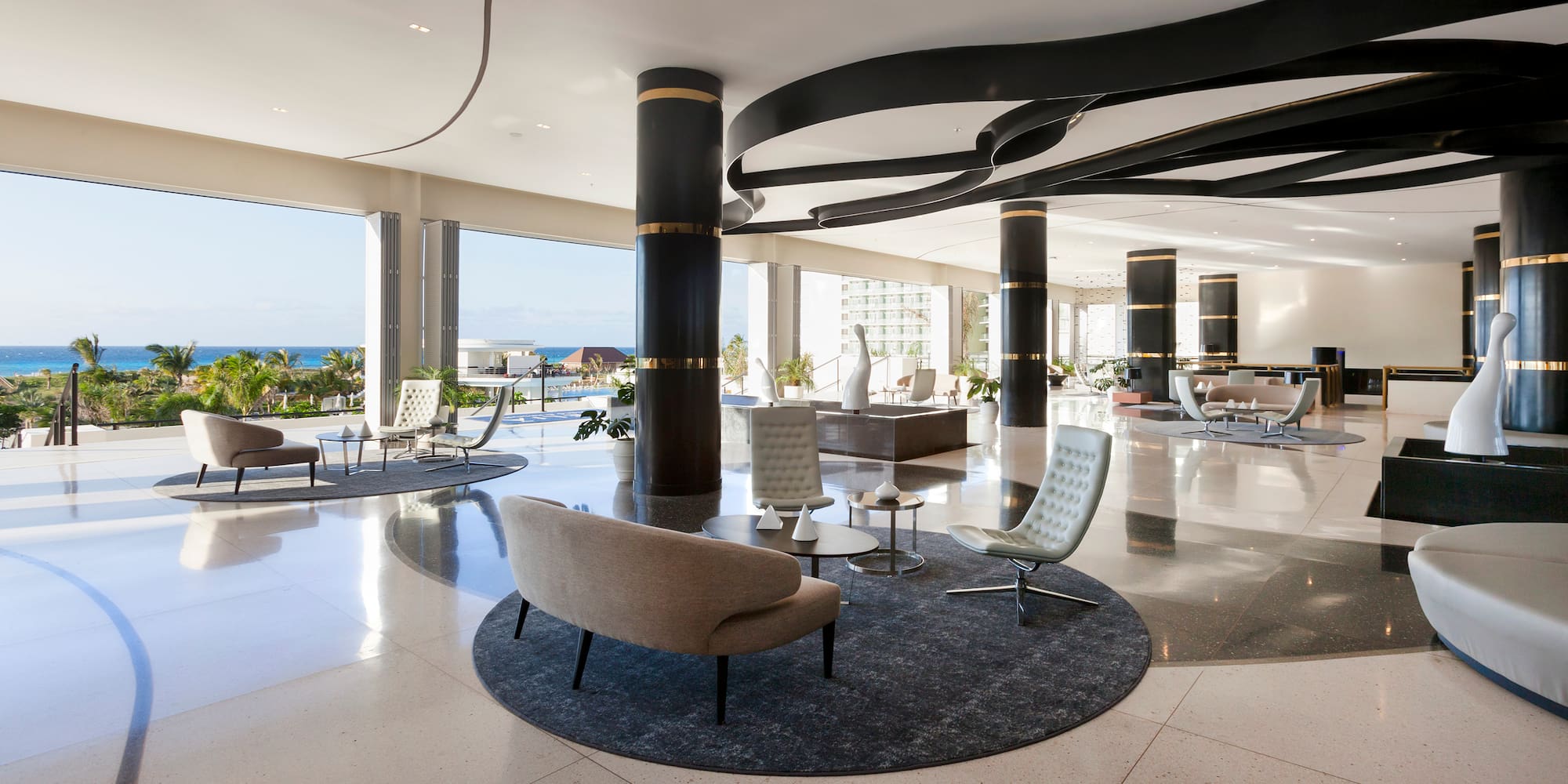 a large room with a large black and white floor and chairs