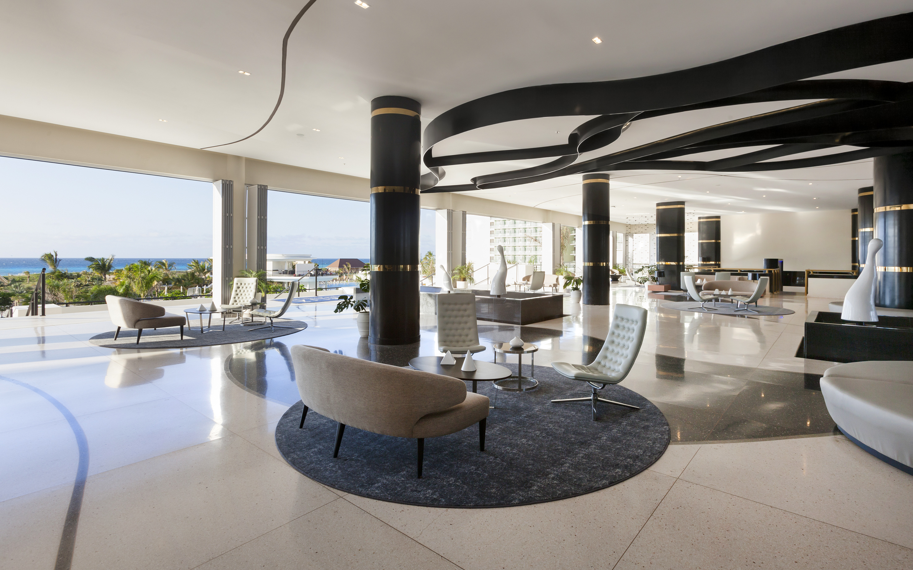 a large room with a large black and white floor and chairs