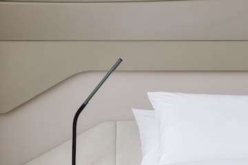 a black lamp on a bed