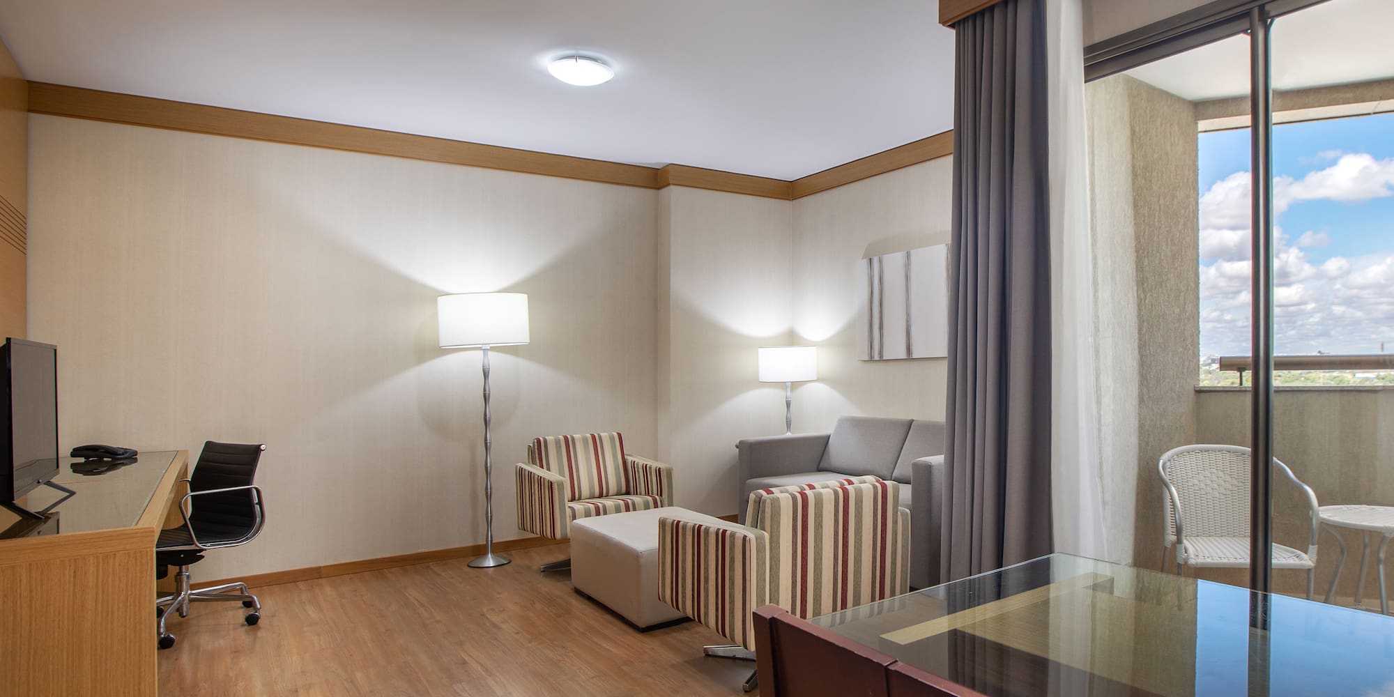 a room with a desk and chairs