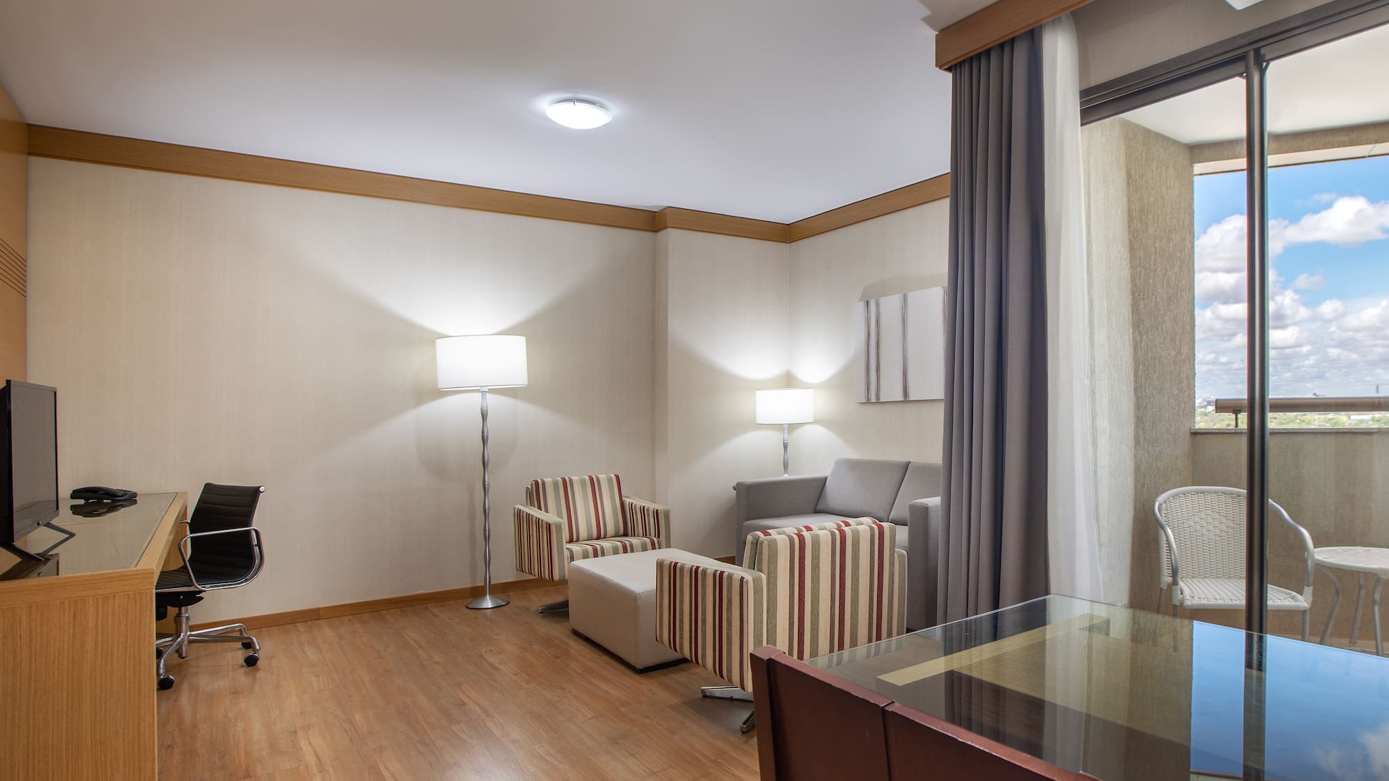 a room with a desk and chairs