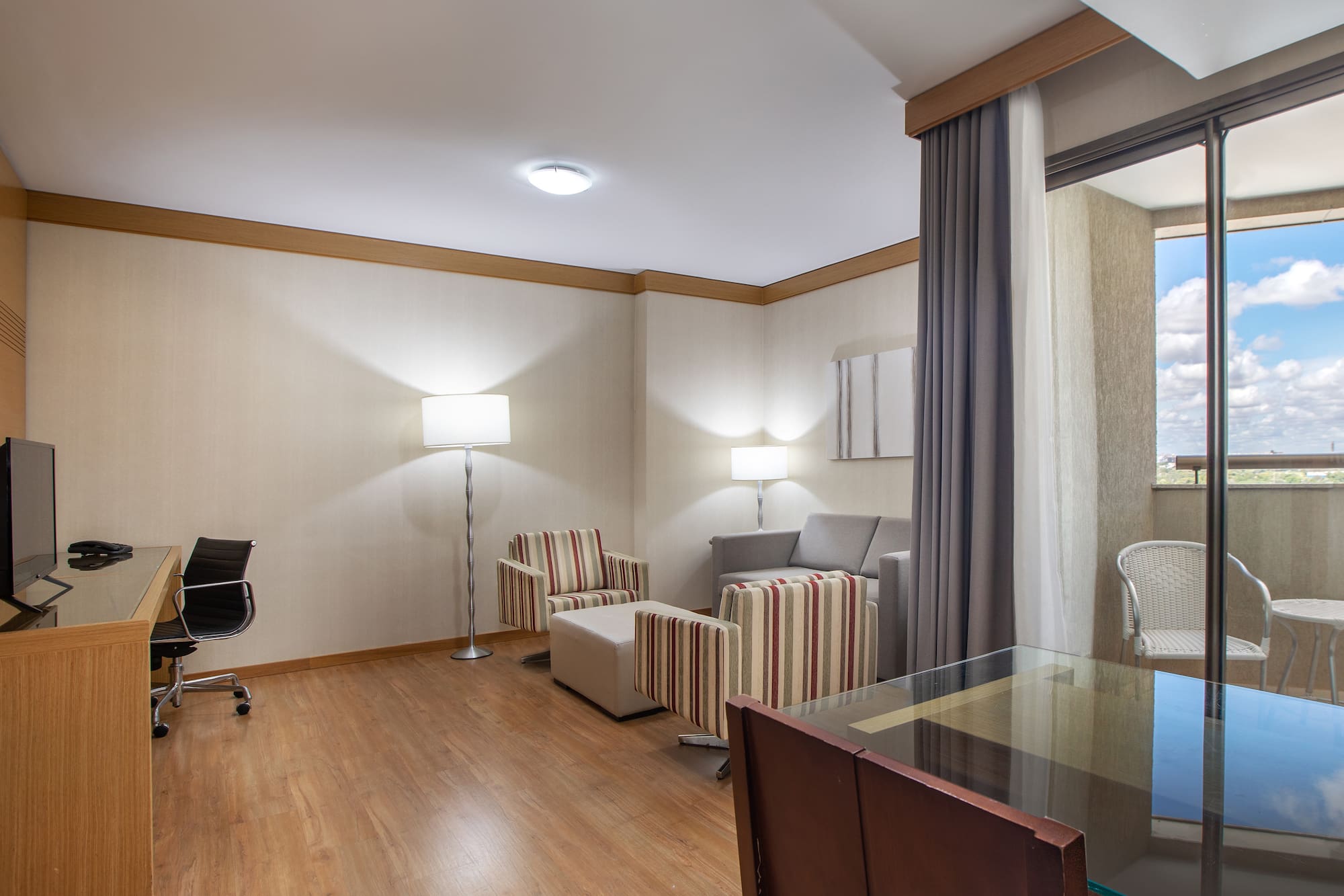 a room with a desk and chairs