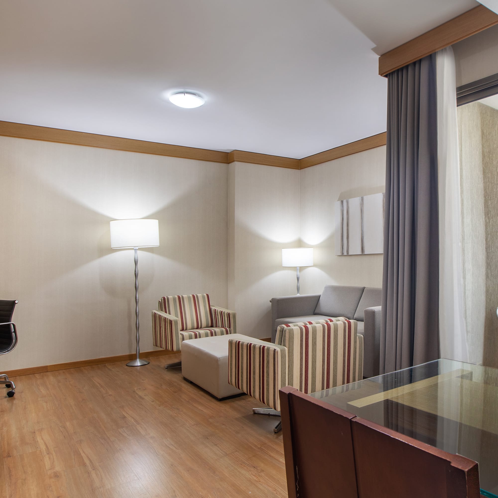 a room with a desk and chairs