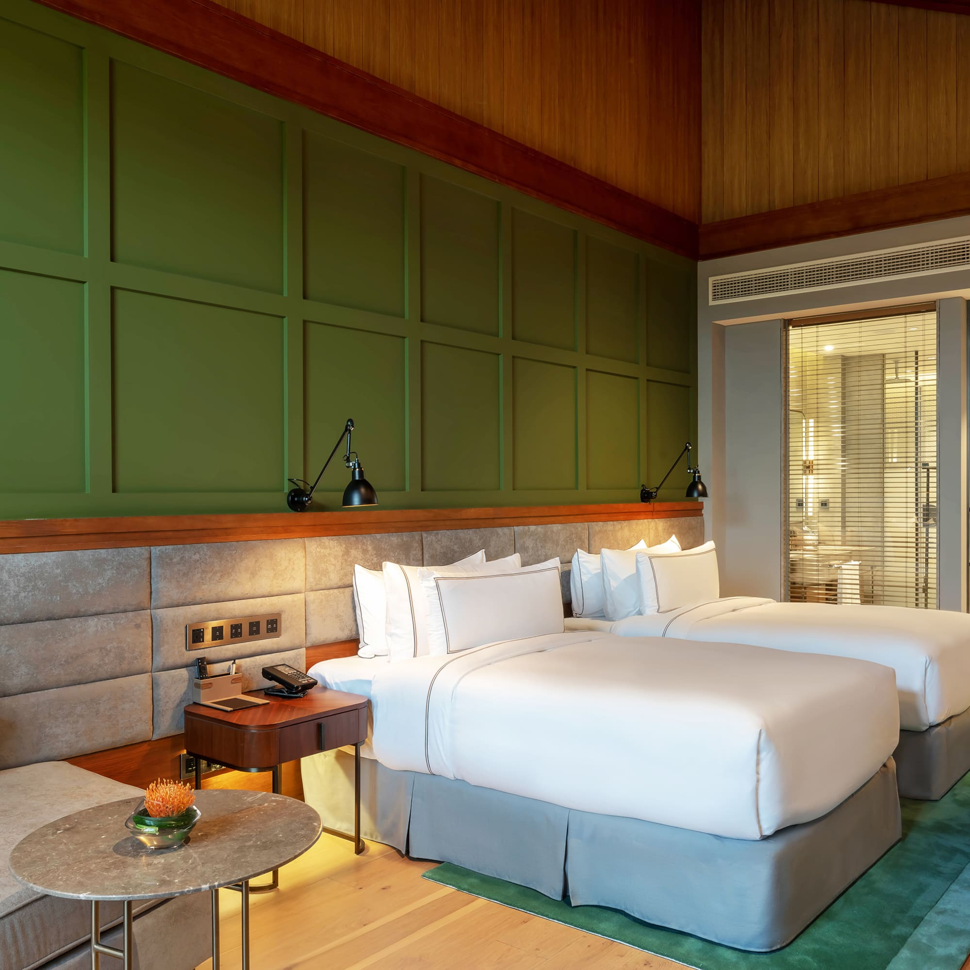 a room with two beds and a table