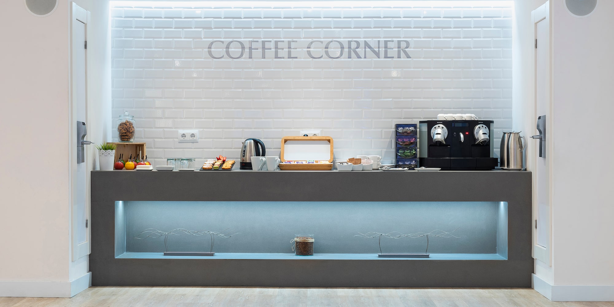 a counter with coffee machines and coffee maker