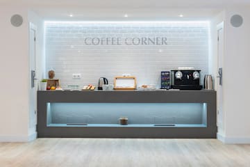a counter with coffee machines and coffee maker