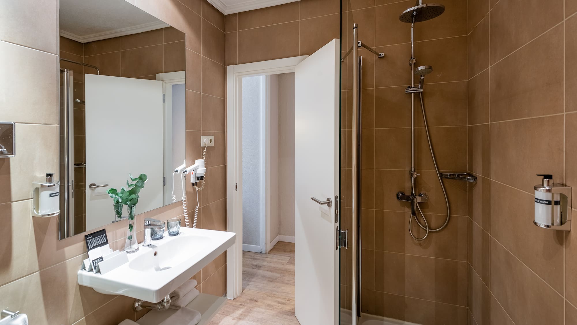 a bathroom with a shower and sink