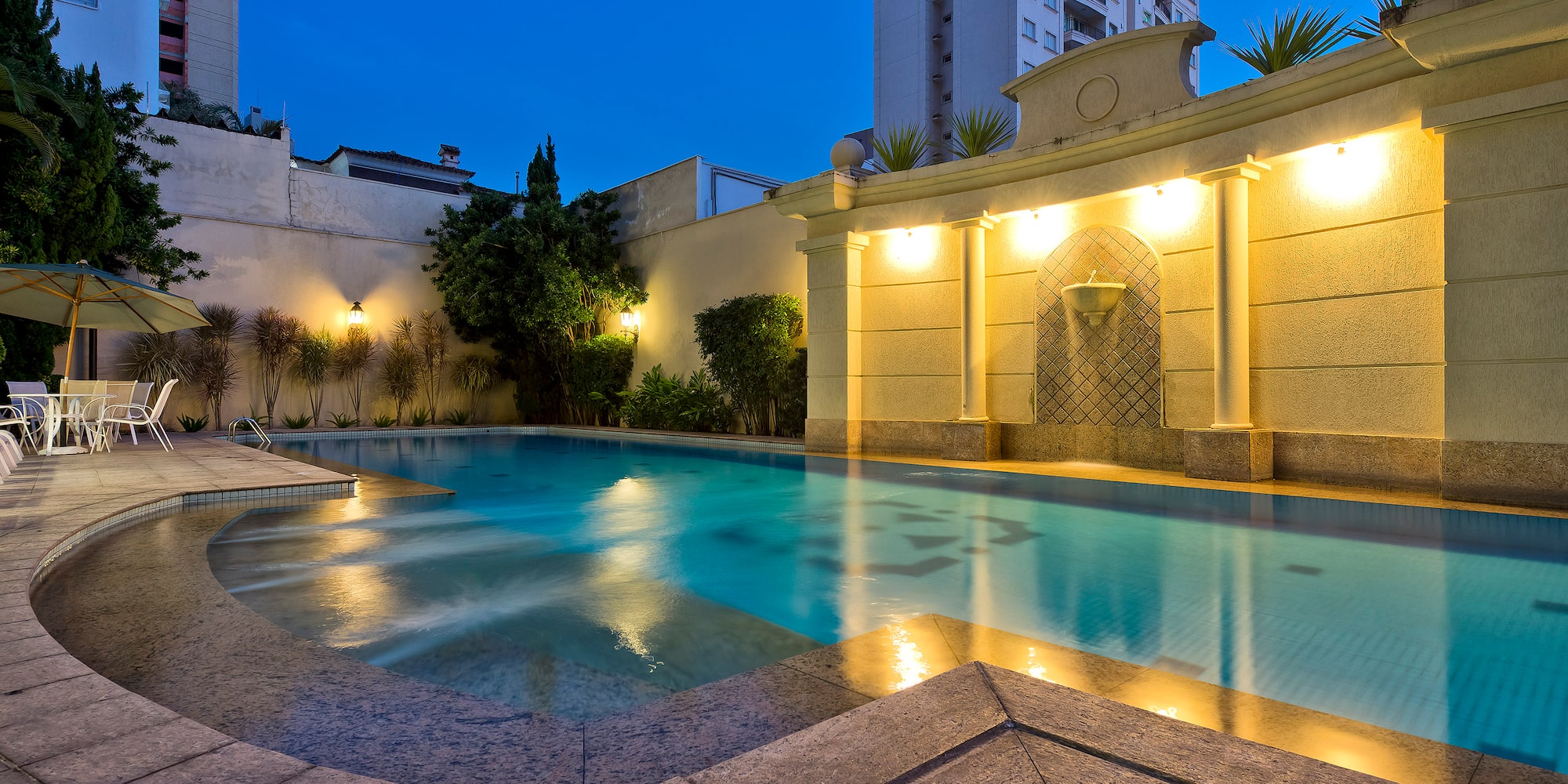 a pool with lights on the side