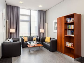 a room with couches and a bookcase