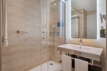 a bathroom with a shower and sink