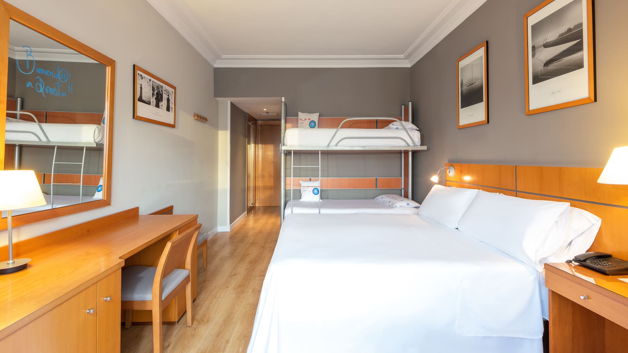 a room with a bunk bed and a desk