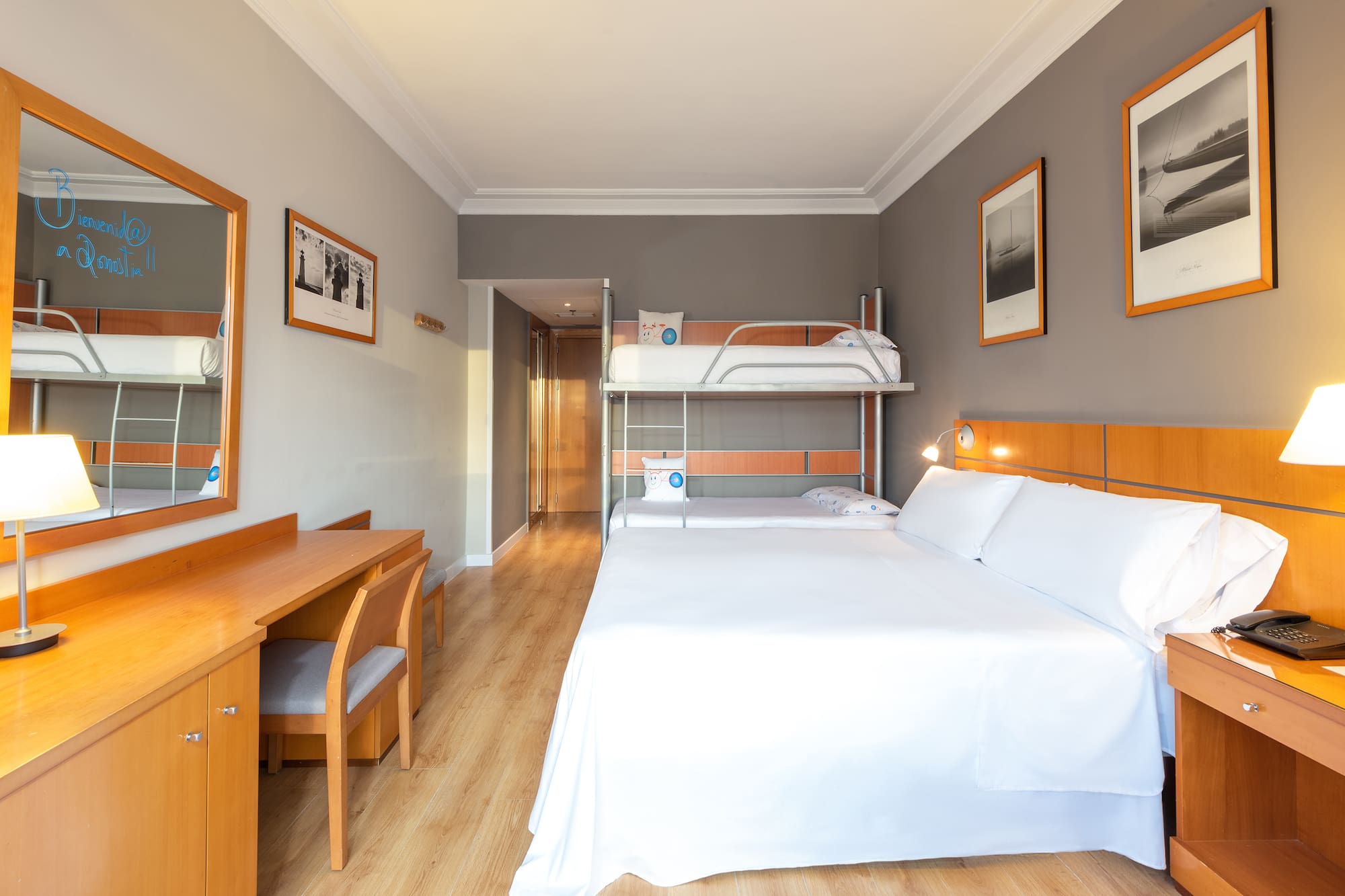 a room with a bunk bed and a desk