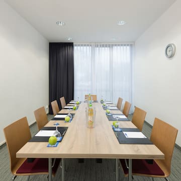 a table with chairs and a clock on the wall