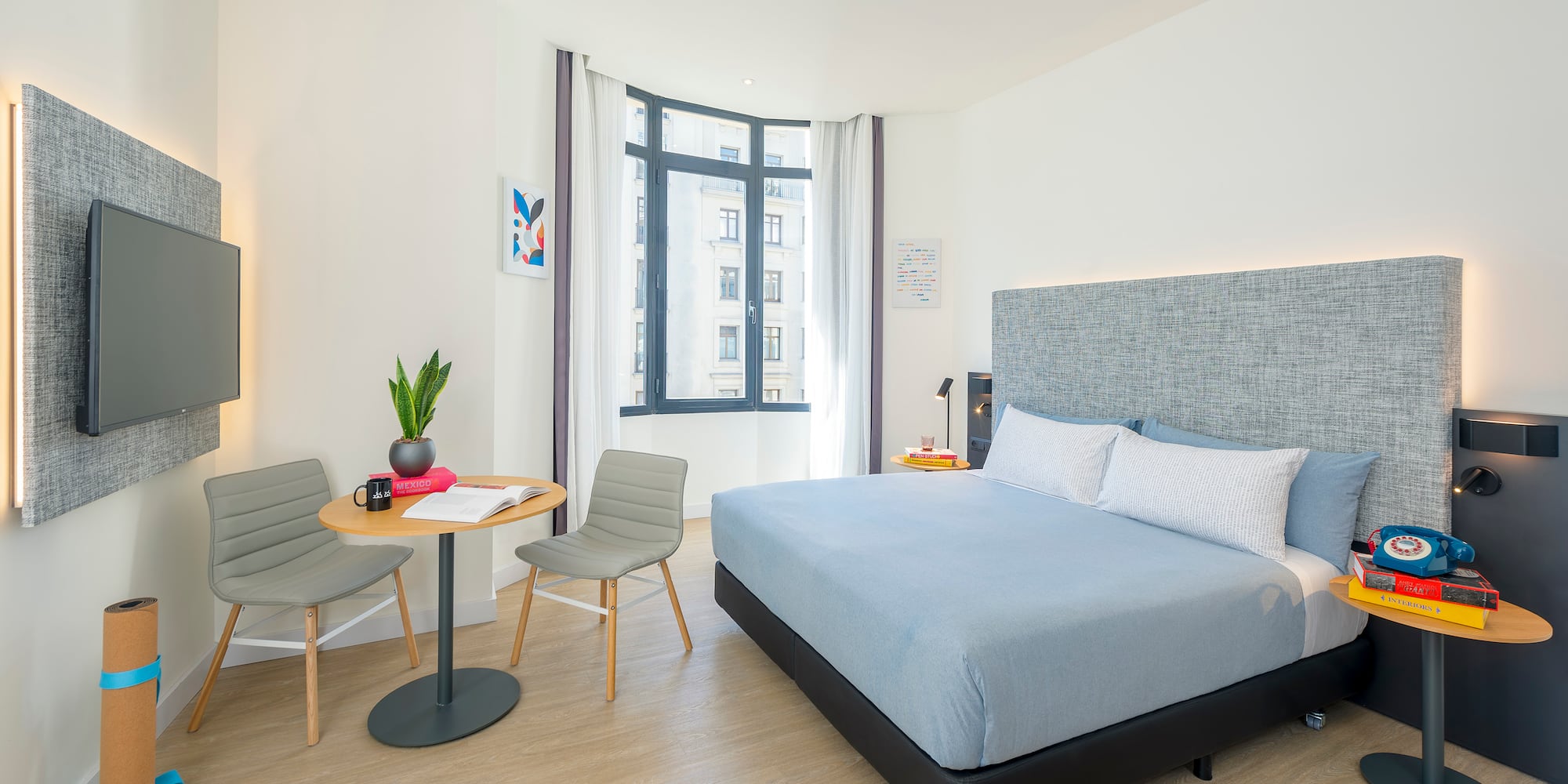 a bedroom with a bed and chairs