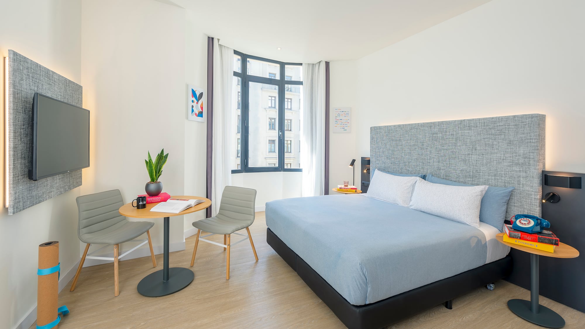 a bedroom with a bed and chairs