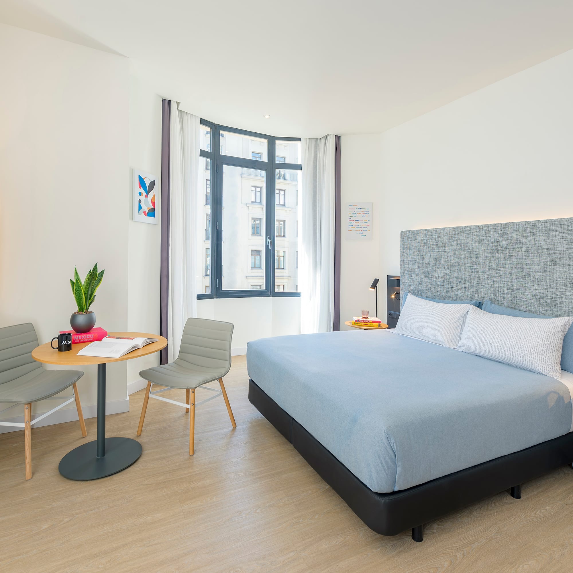 a bedroom with a bed and chairs