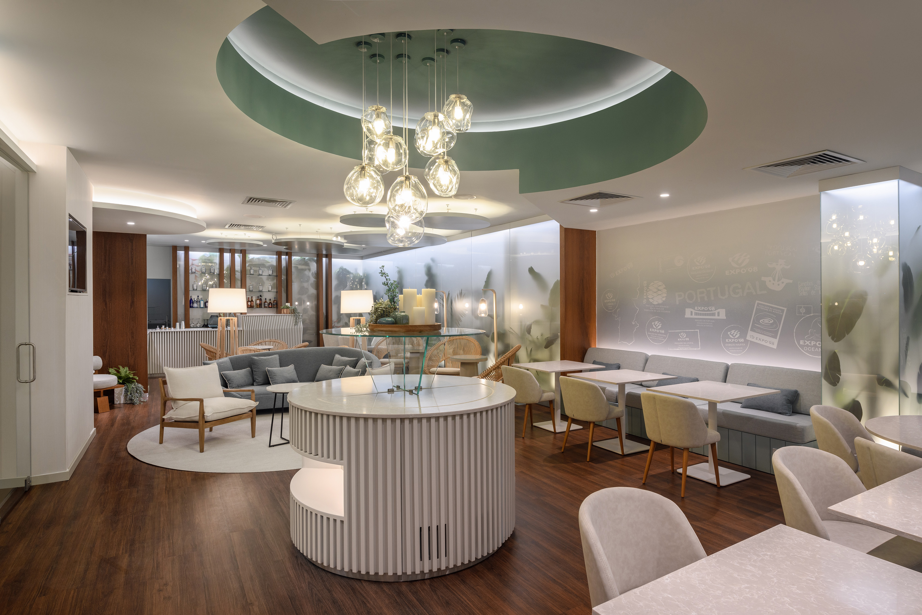 Modern lounge interior with circular ceiling lights, wood floor, and diverse seating.