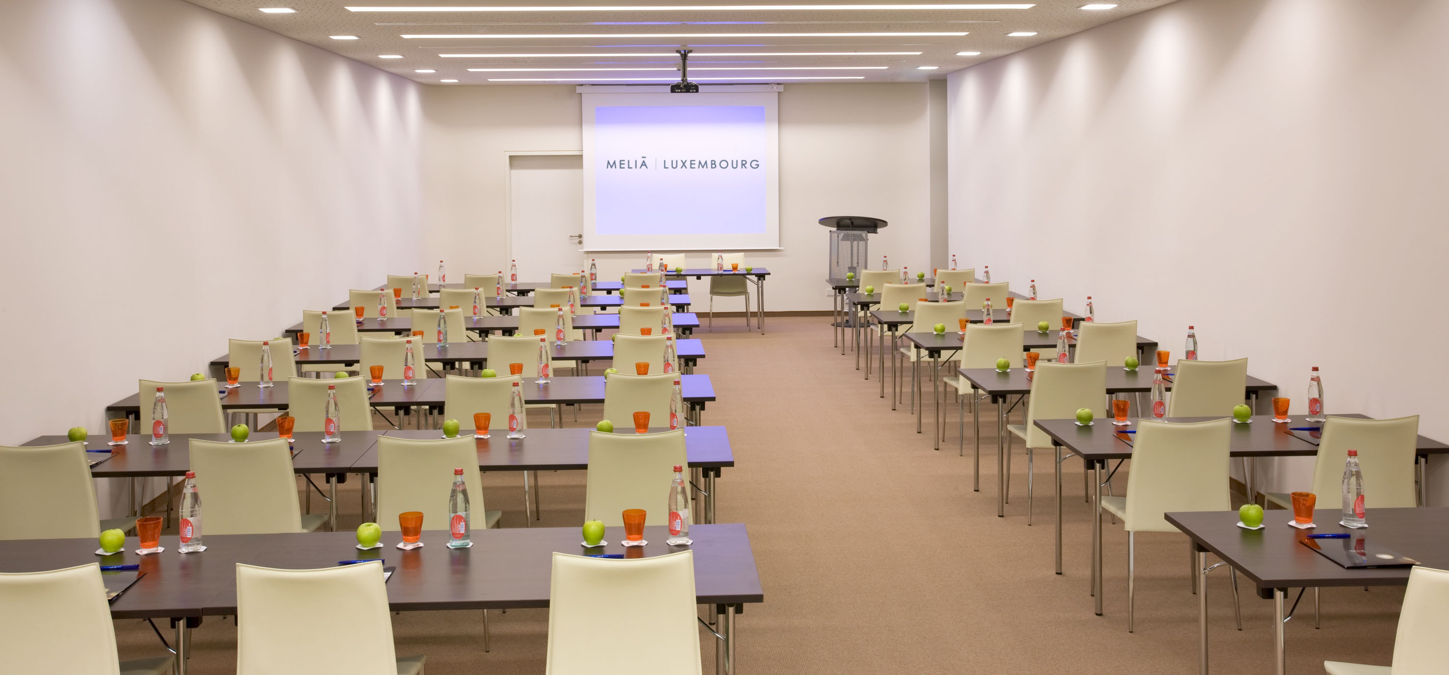 Melia Luxembourg conference room, set for a meeting with projector screen.