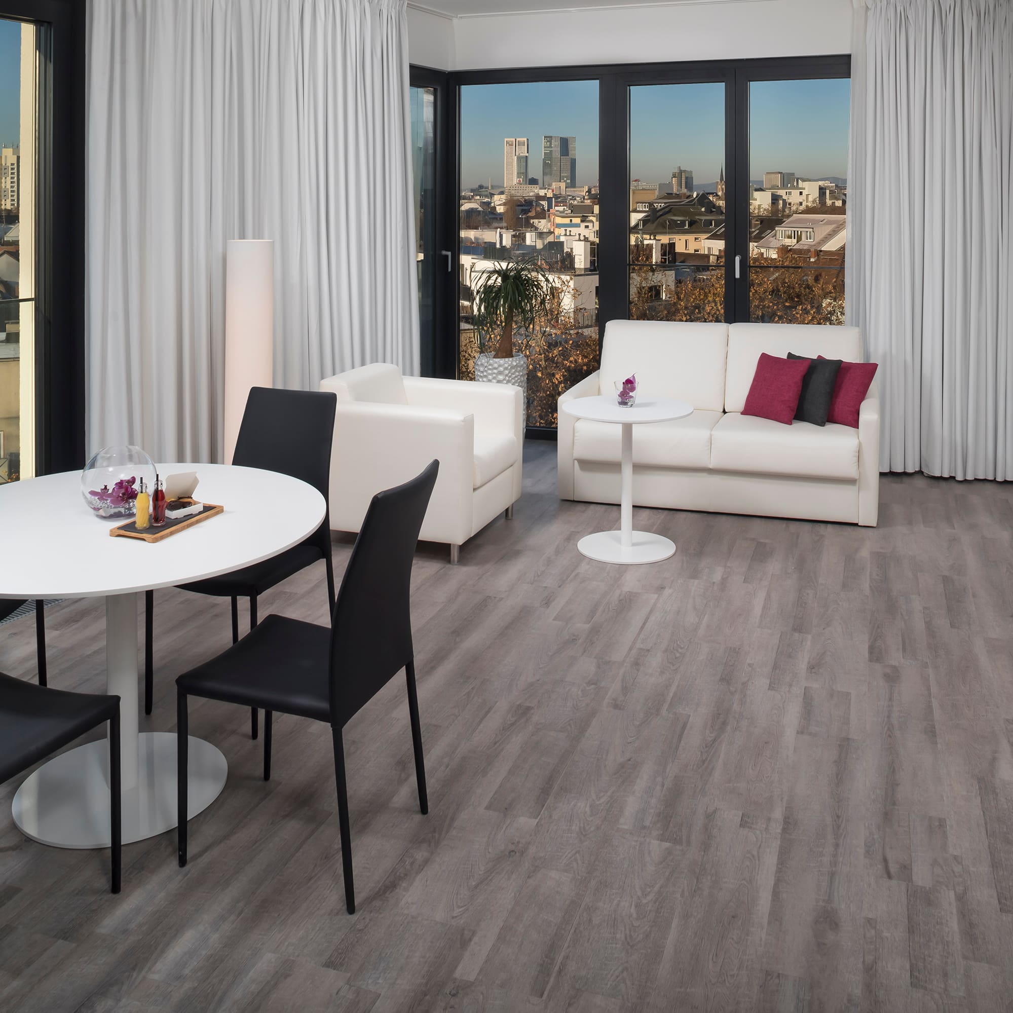 a room with white furniture and a table