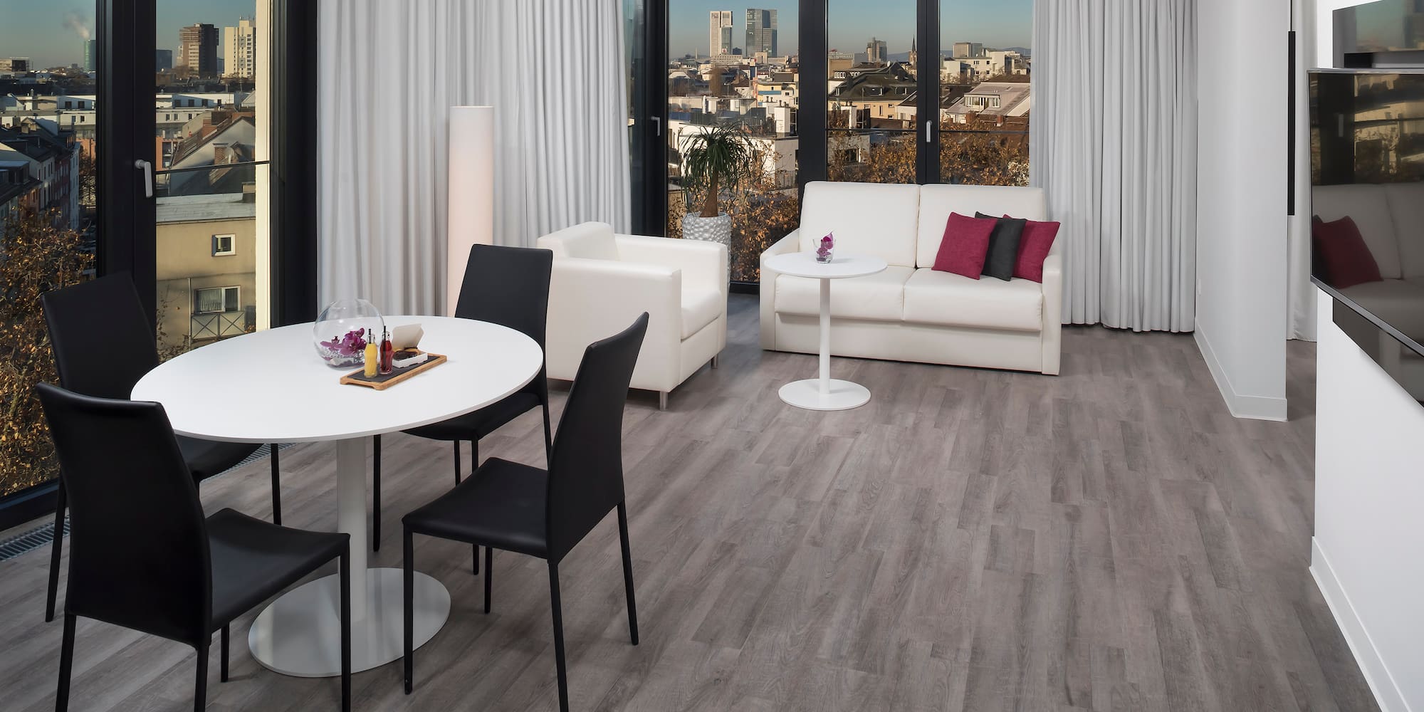 a room with white furniture and a table