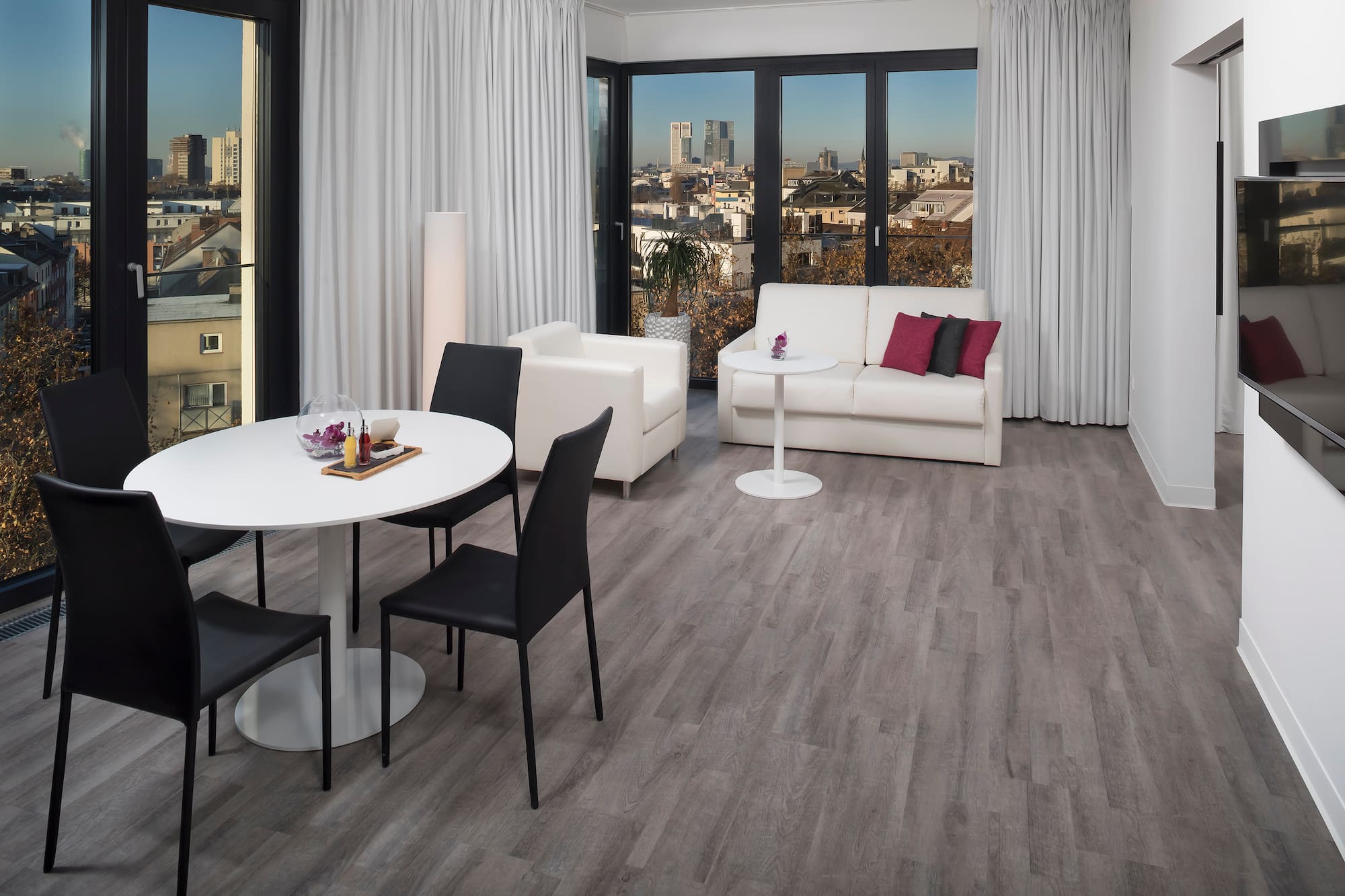 a room with white furniture and a table