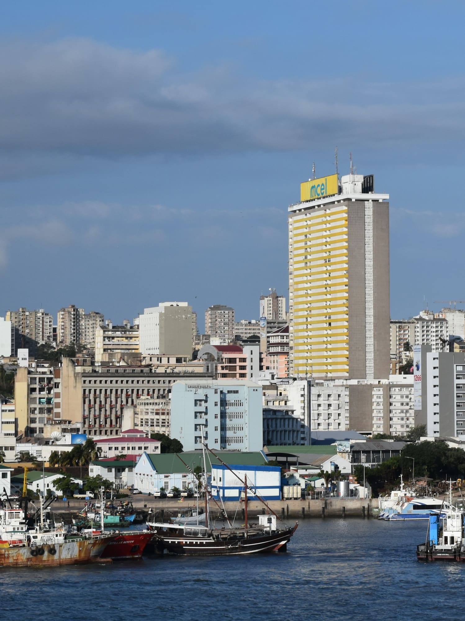 boats in a body of water with a city in the background