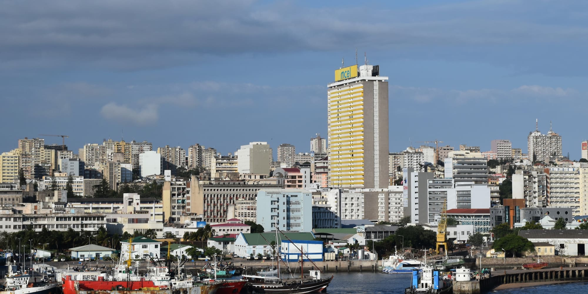 boats in a body of water with a city in the background