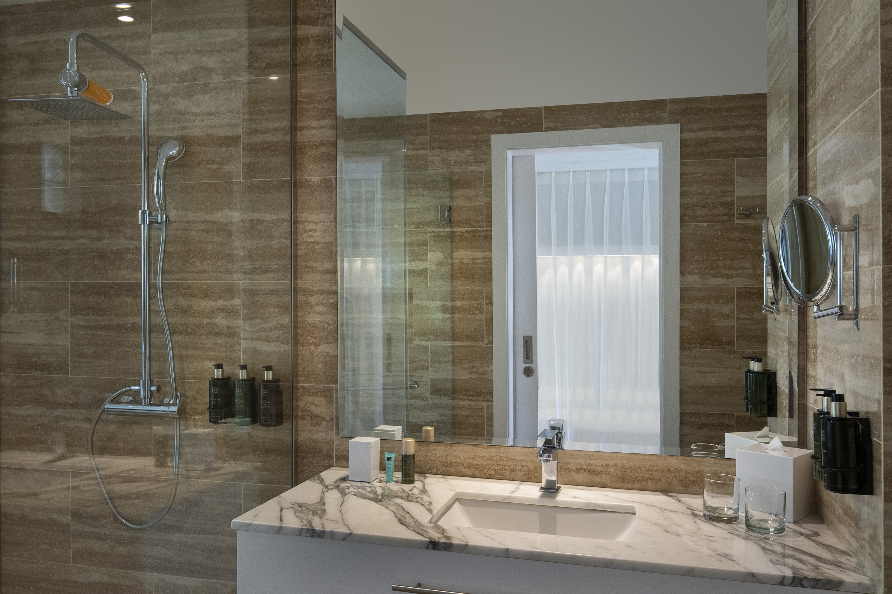 a bathroom with a marble countertop and shower