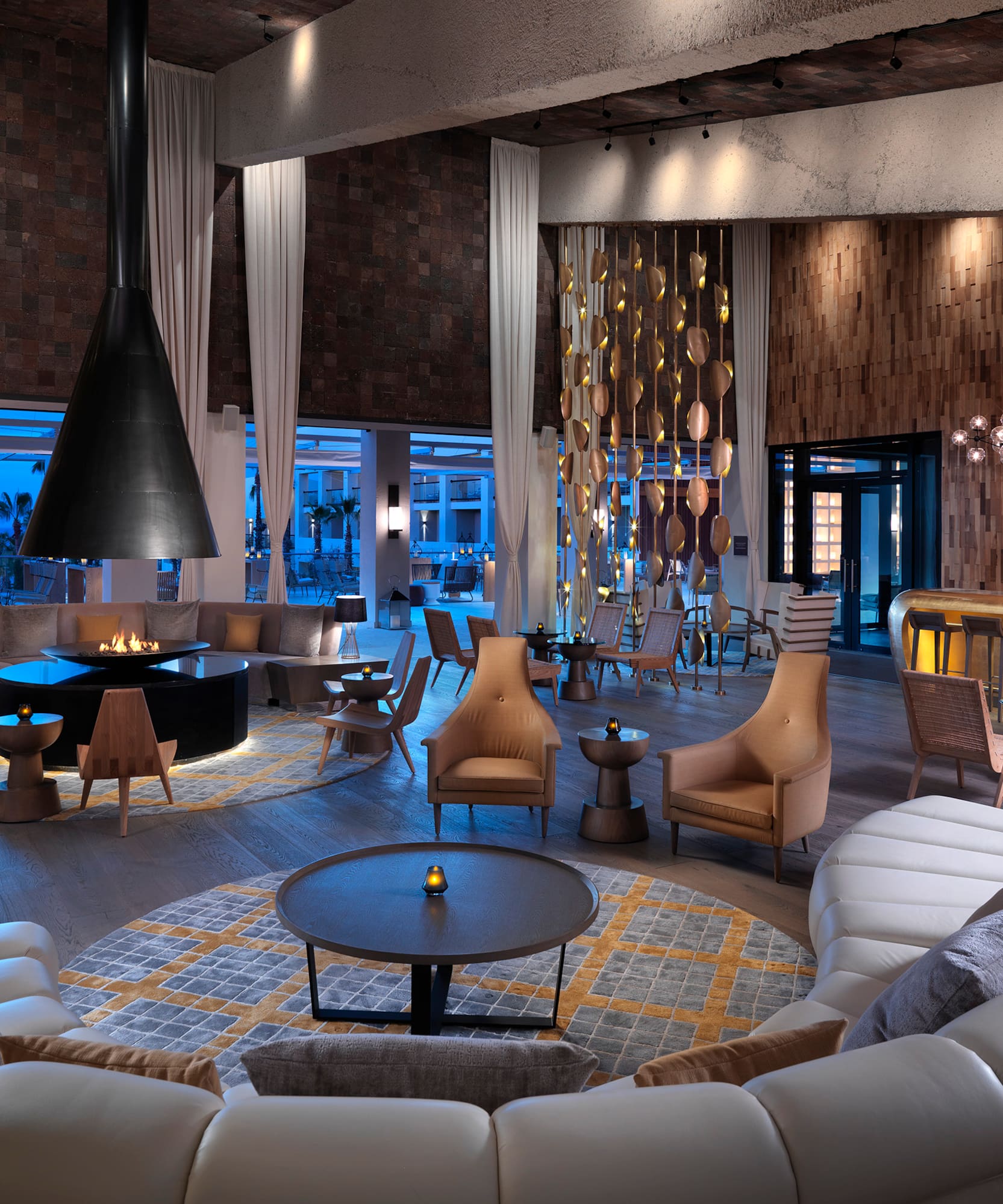 a room with a large round table and chairs