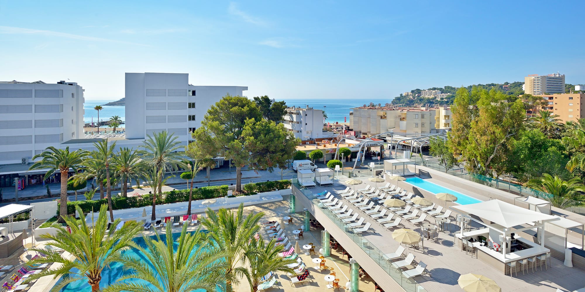 a swimming pool and a building with trees and buildings