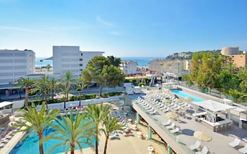 a swimming pool and a building with trees and buildings