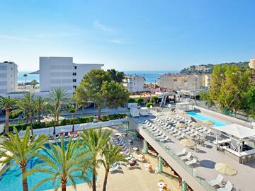 a swimming pool and a building with palm trees